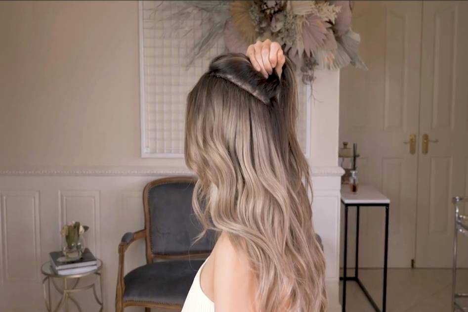 Close-up of sun-kissed hair with golden highlights cascading over shoulders