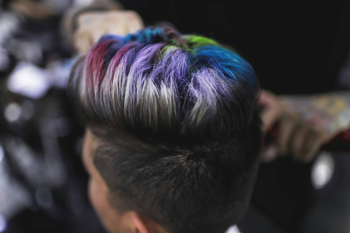 Client receiving professional hair highlight salon service with foil technique